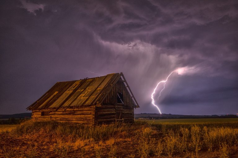 Barn with a lighting strike in the background